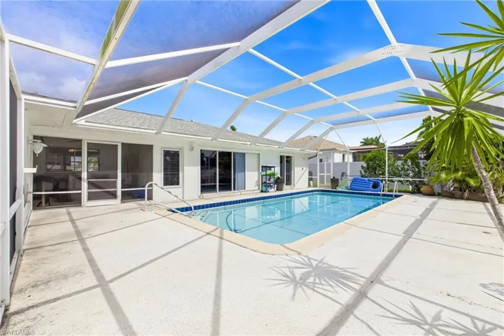The spacious pool deck offers plenty of room for sunbathing, dining, and gathering with family and friends.