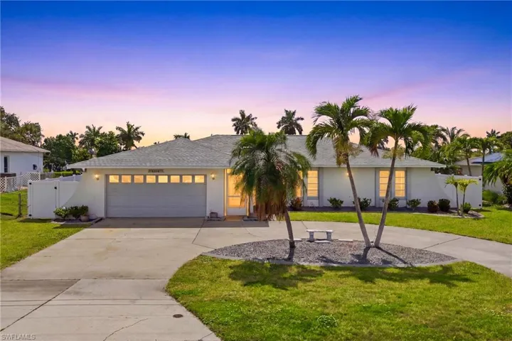 This beautifully maintained Gulf-access residence offers a warm welcome with attractive landscaping, a spacious driveway, and timeless Florida charm.