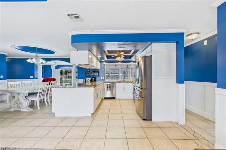 The open-concept kitchen flows seamlessly into the living and dining areas, making entertaining a breeze.