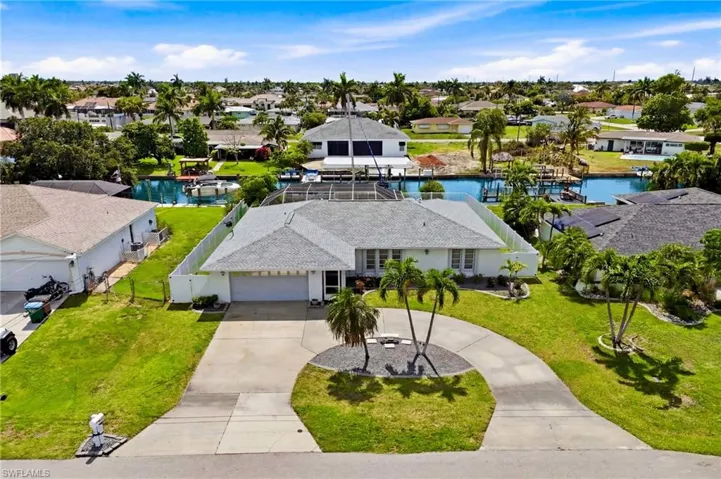 A bird's-eye view highlights the home's spacious lot, waterfront position, and easy access to open water adventures.