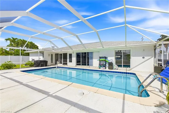 Your private tropical oasis awaits with a heated pool and expansive outdoor living area.