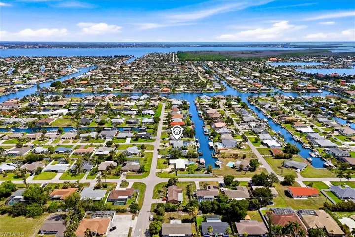 An impressive aerial perspective showcasing the home's prime canal-front location, direct Gulf access, and close proximity to some of Southwest Florida's best boating destinations.
