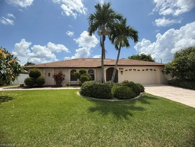 Single-story residence featuring a tan exterior and a brown shingle roof