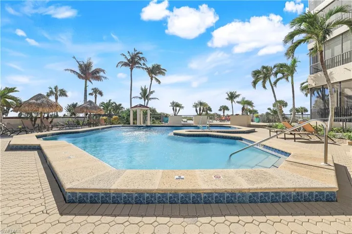 View of swimming pool featuring a patio area, a community hot tub, and a gazebo