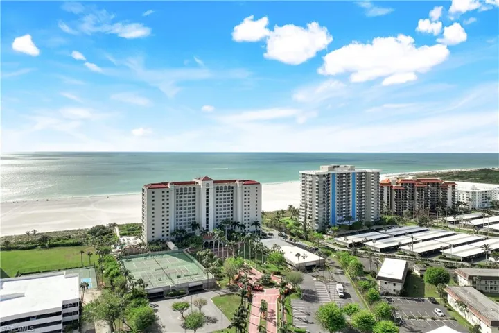 Drone / aerial view with a water view and a view of the beach