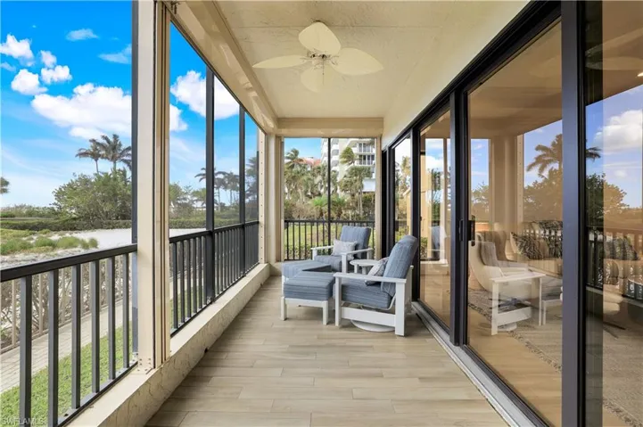 Sunroom / solarium featuring ceiling fan