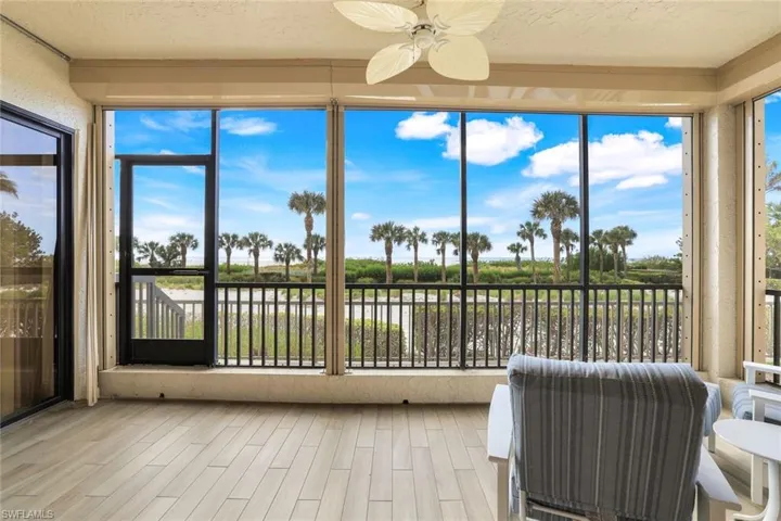 Sunroom / solarium featuring ceiling fan