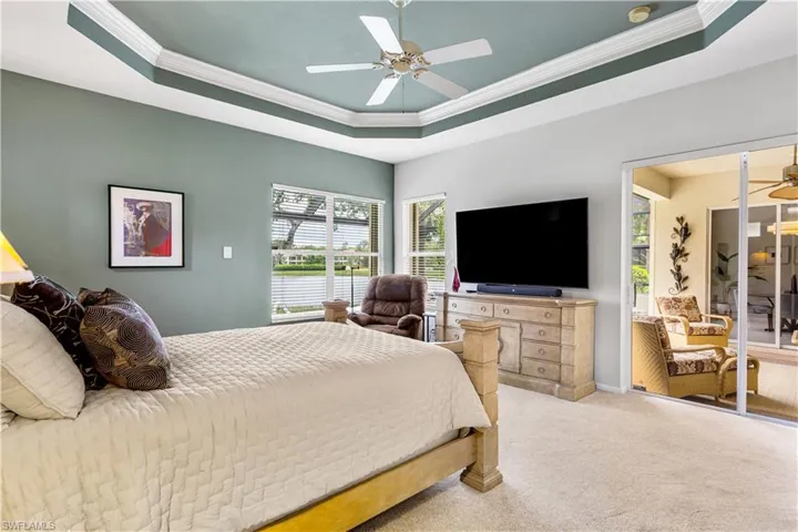 Primary Bedroom lake views and slider to lanai