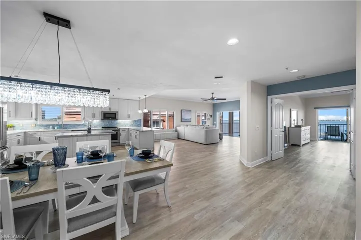 Dining area with light wood-style flooring, plenty of natural light, recessed lighting, and a chandelier