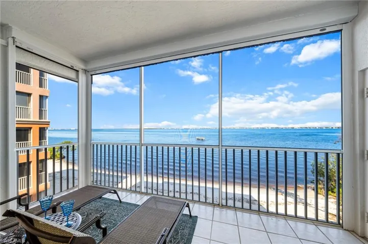 Sunroom / solarium featuring a water view