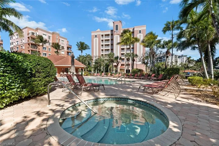 Community pool featuring a patio and a hot tub