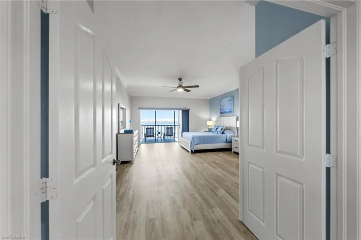 Bedroom with access to exterior, light wood-style floors, and ceiling fan