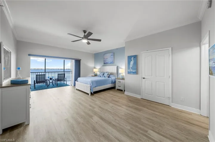Bedroom featuring crown molding, access to exterior, light wood-style flooring, and ceiling fan