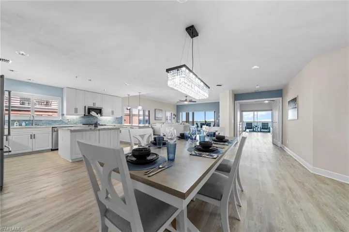 Dining area with light wood-style floors, a ceiling fan, and recessed lighting