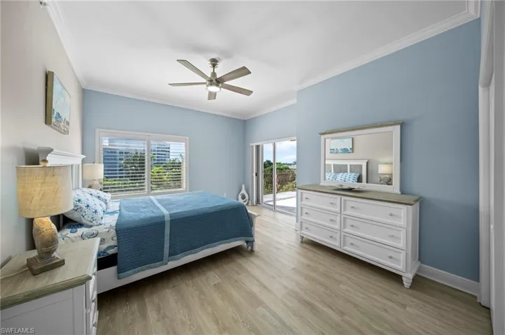 Bedroom featuring crown molding, light wood-style flooring, access to exterior, and ceiling fan