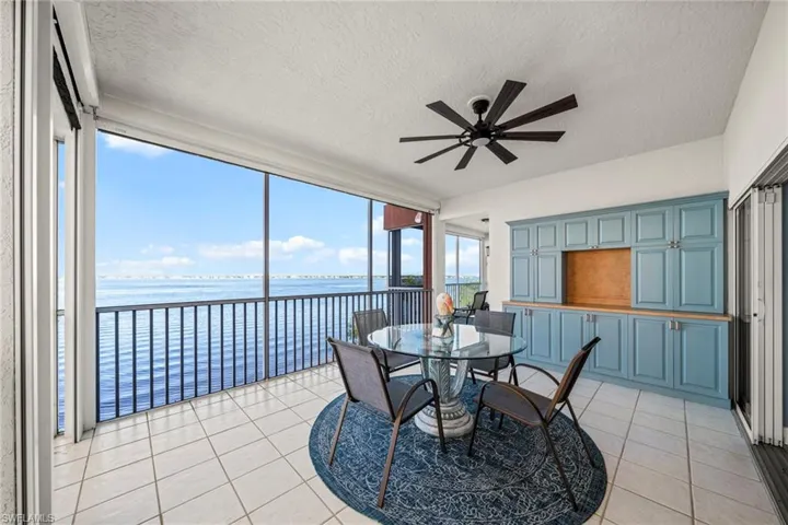 Sunroom / solarium featuring a water view