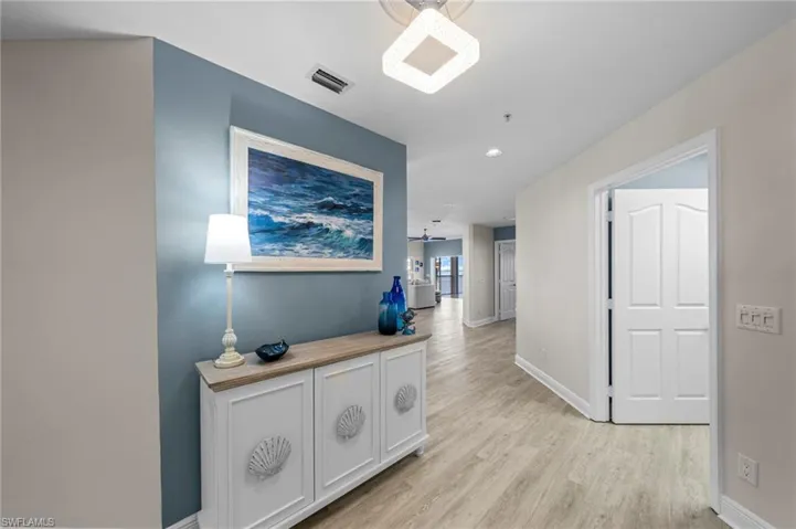 Hallway featuring light wood-style flooring and recessed lighting