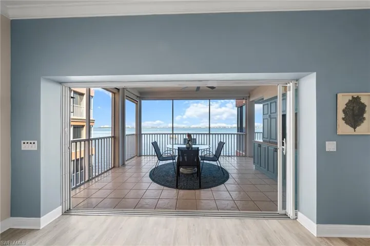 Living room overlooking large lanai that overlooks Caloosahatchee River & private beach.