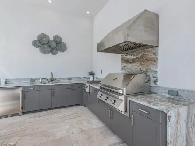 View of patio with area for grilling and a sink