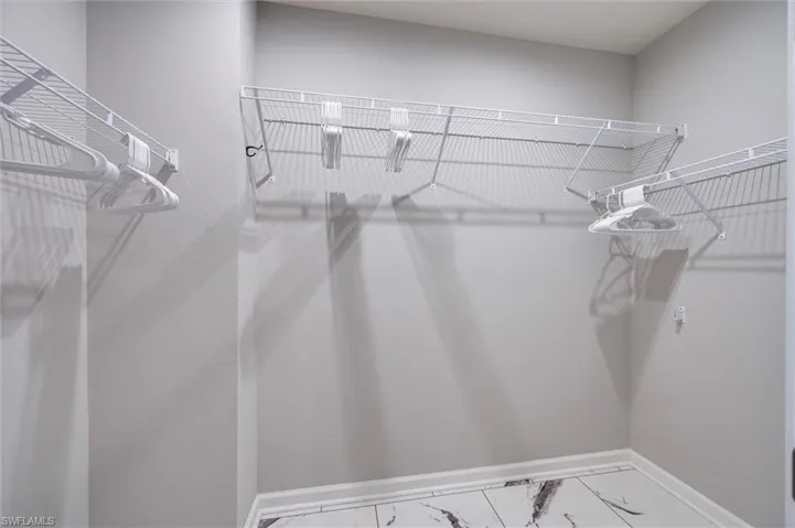 Spacious walk-in closet with tile flooring