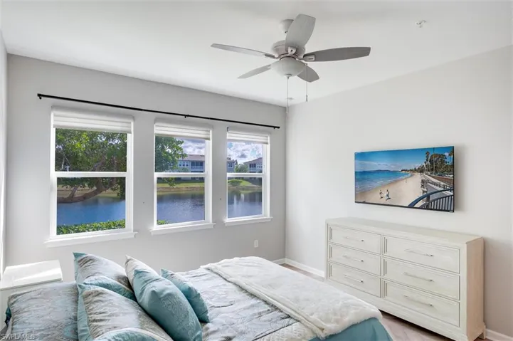 Primary bedroom has a queen size bed, a ceiling fan, TV