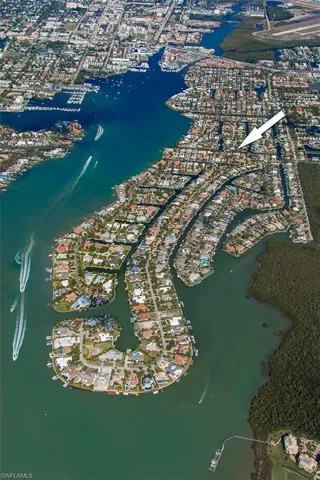 Aerial view of property and surrounding area featuring a nearby body of water