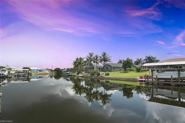 Water view featuring boat lift and a dock