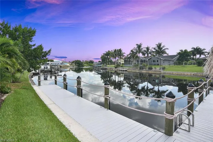 Dock area featuring a water view and a yard