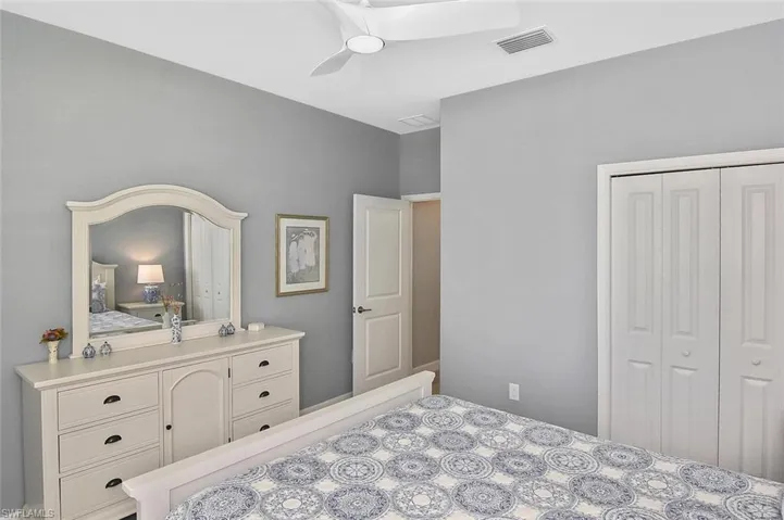 Kitchen with a chandelier, open floor plan, white cabinets, decorative light fixtures, and light countertops