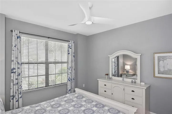 Kitchen with stainless steel appliances, a kitchen breakfast bar, white cabinets, and recessed lighting