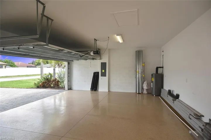 Living area with arched walkways, tile patterned flooring, and recessed lighting