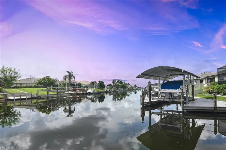 Dock area with boat lift and a water view