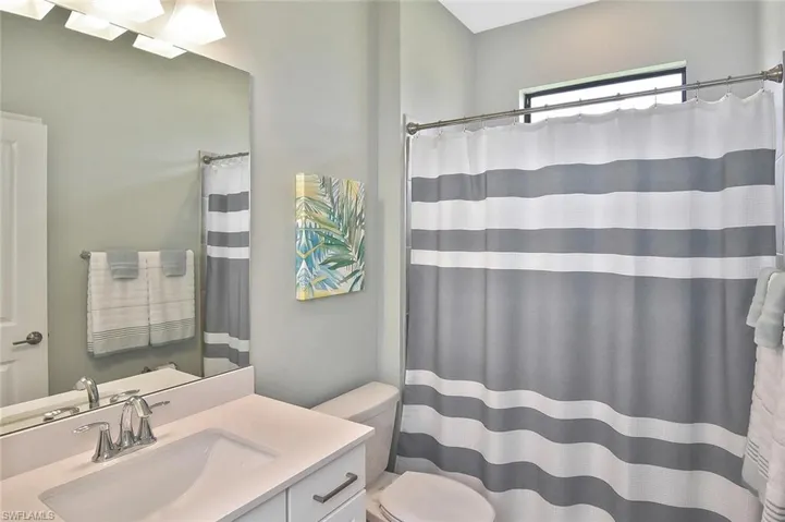 Full bath featuring vanity and a shower with curtain