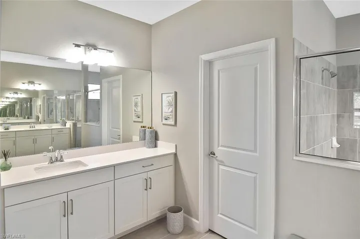 Full bathroom with tiled shower and vanity