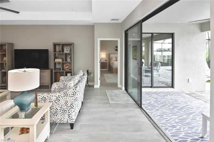 Living room featuring a ceiling fan and recessed lighting