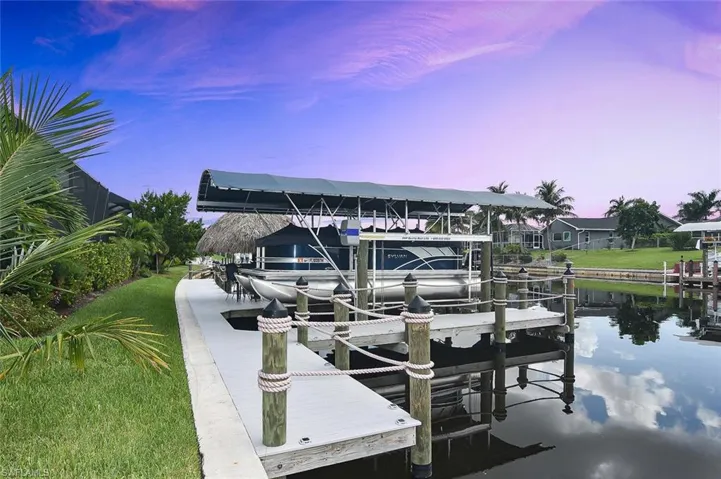 Dock area with boat lift and a water view