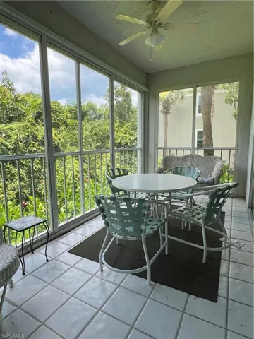 Sunroom / solarium featuring ceiling fan