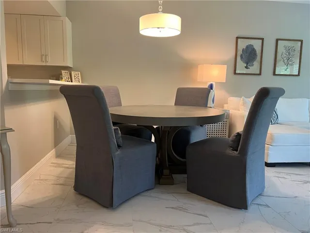 Dining space with light tile patterned floors