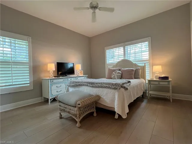 Bedroom with ceiling fan and wood-type flooring