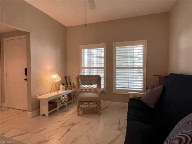 Sitting room with ceiling fan and tile patterned flooring