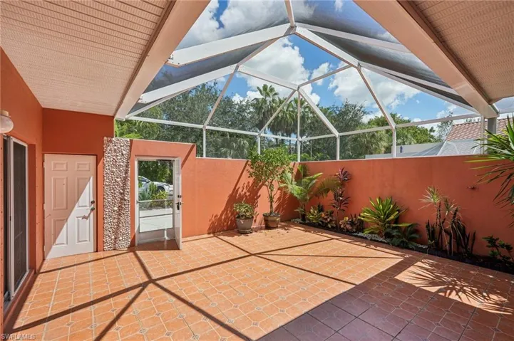 View of patio / terrace featuring glass enclosure and a sunroom