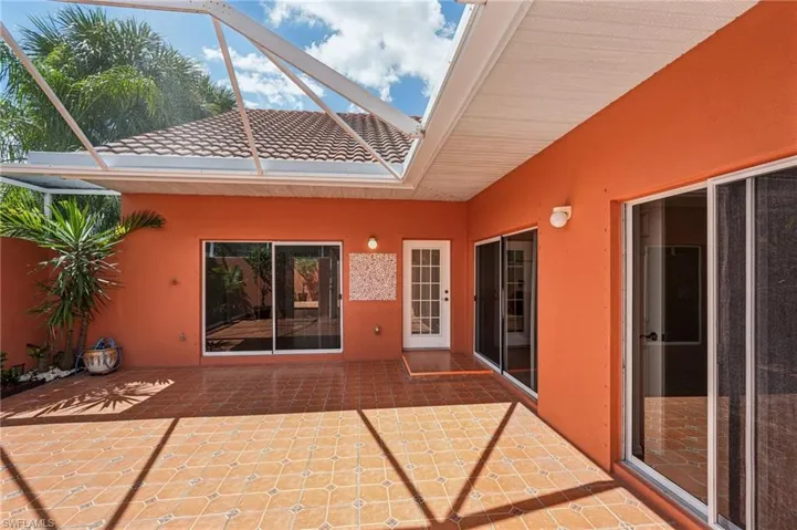 View of patio featuring a lanai