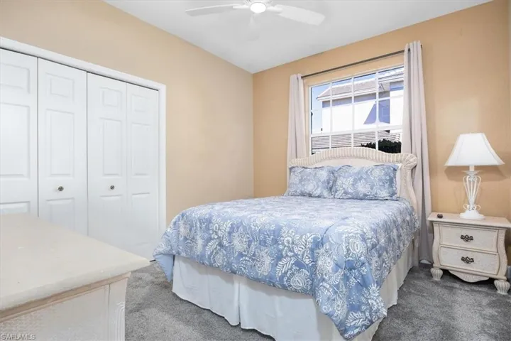 Bedroom with a closet, carpet flooring, and a ceiling fan