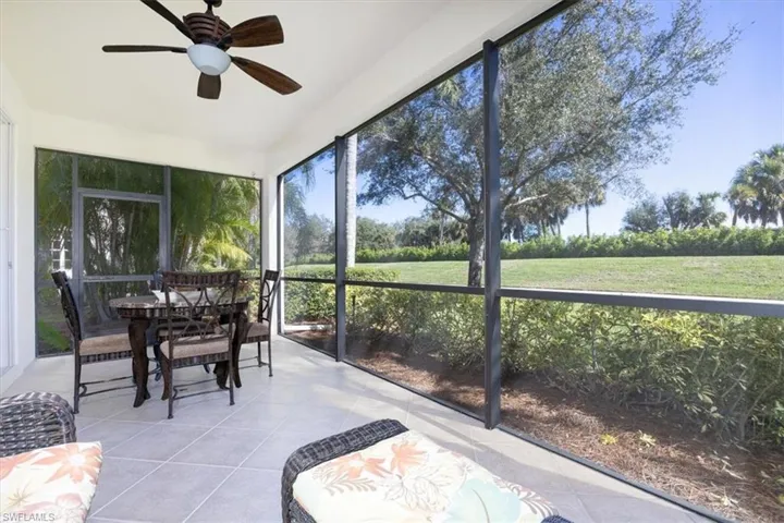 Sunroom / solarium with ceiling fan and outdoor dining area