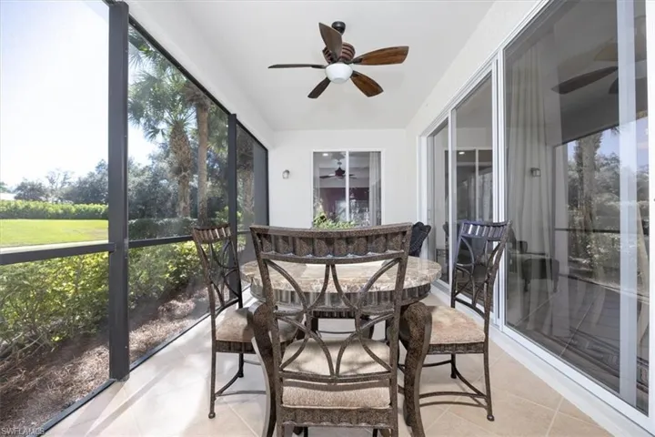 Sunroom featuring a ceiling fan and outdoor dining area