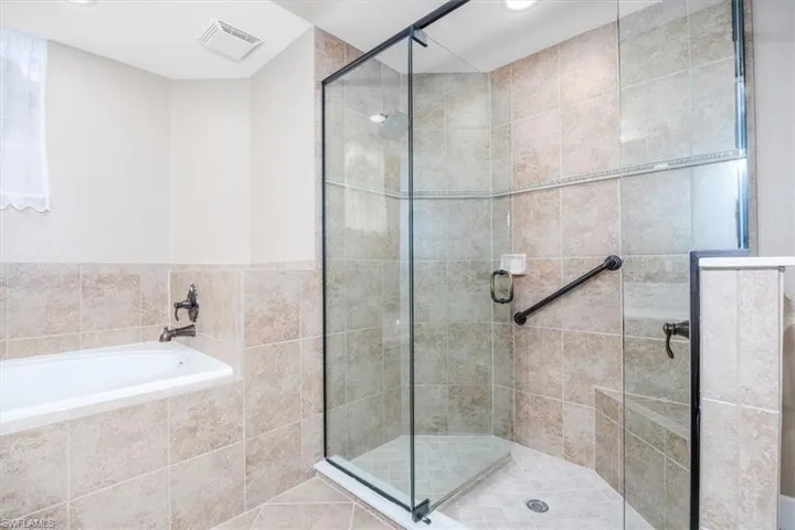 Full bath with a stall shower and a garden tub