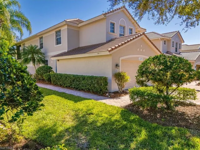 Mediterranean / spanish-style house featuring a front lawn, stucco siding, an attached garage, and a tile roof