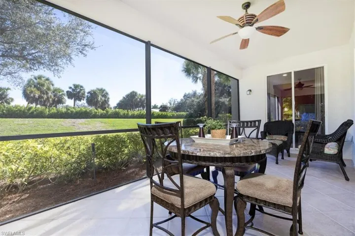 Sunroom featuring outdoor dining area and a ceiling fan