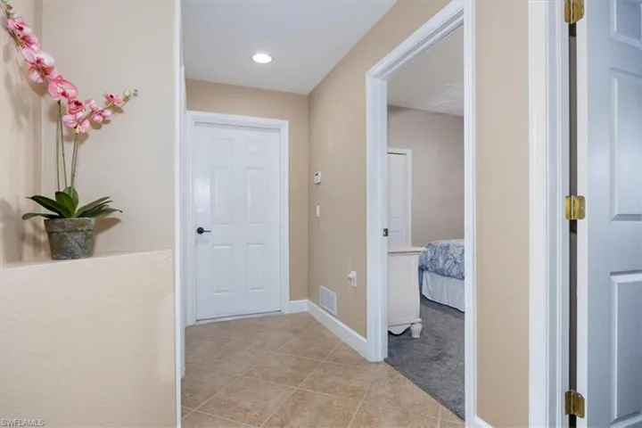 Hall featuring light tile patterned floors and recessed lighting