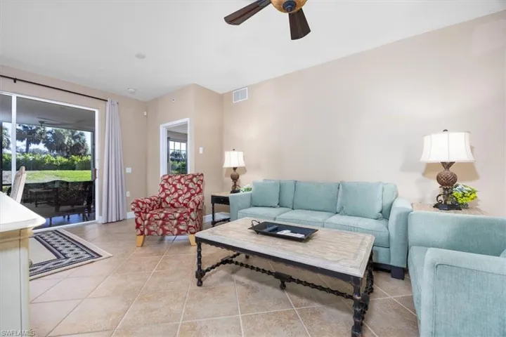Living area featuring ceiling fan and light tile patterned floors